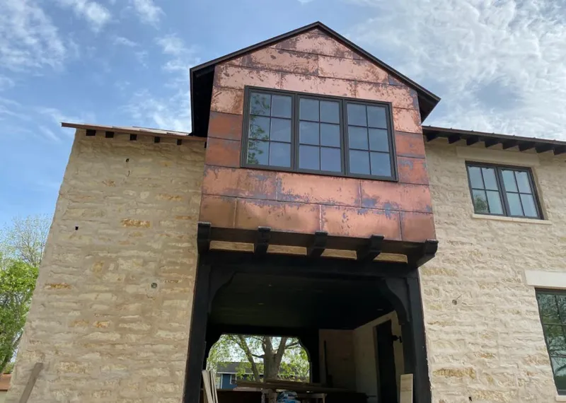 Copper metal panel facade on a stone building for Skylight Installation in Minnehaha